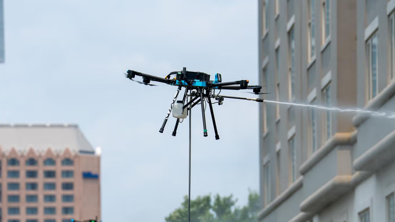 Commercial cleaning drone washing a high building exterior